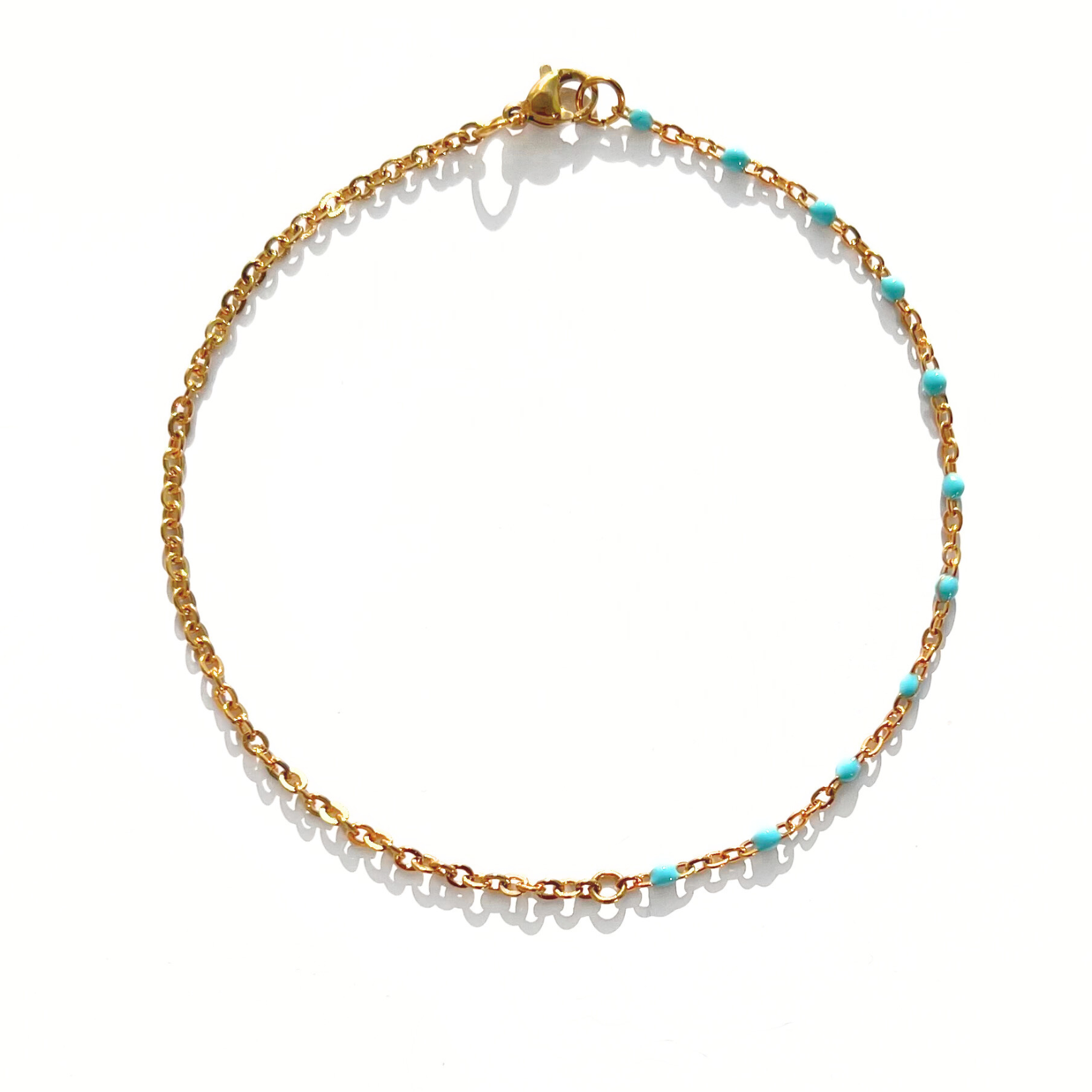 Chaîne cheville boules turquoises  et chaîne dorée